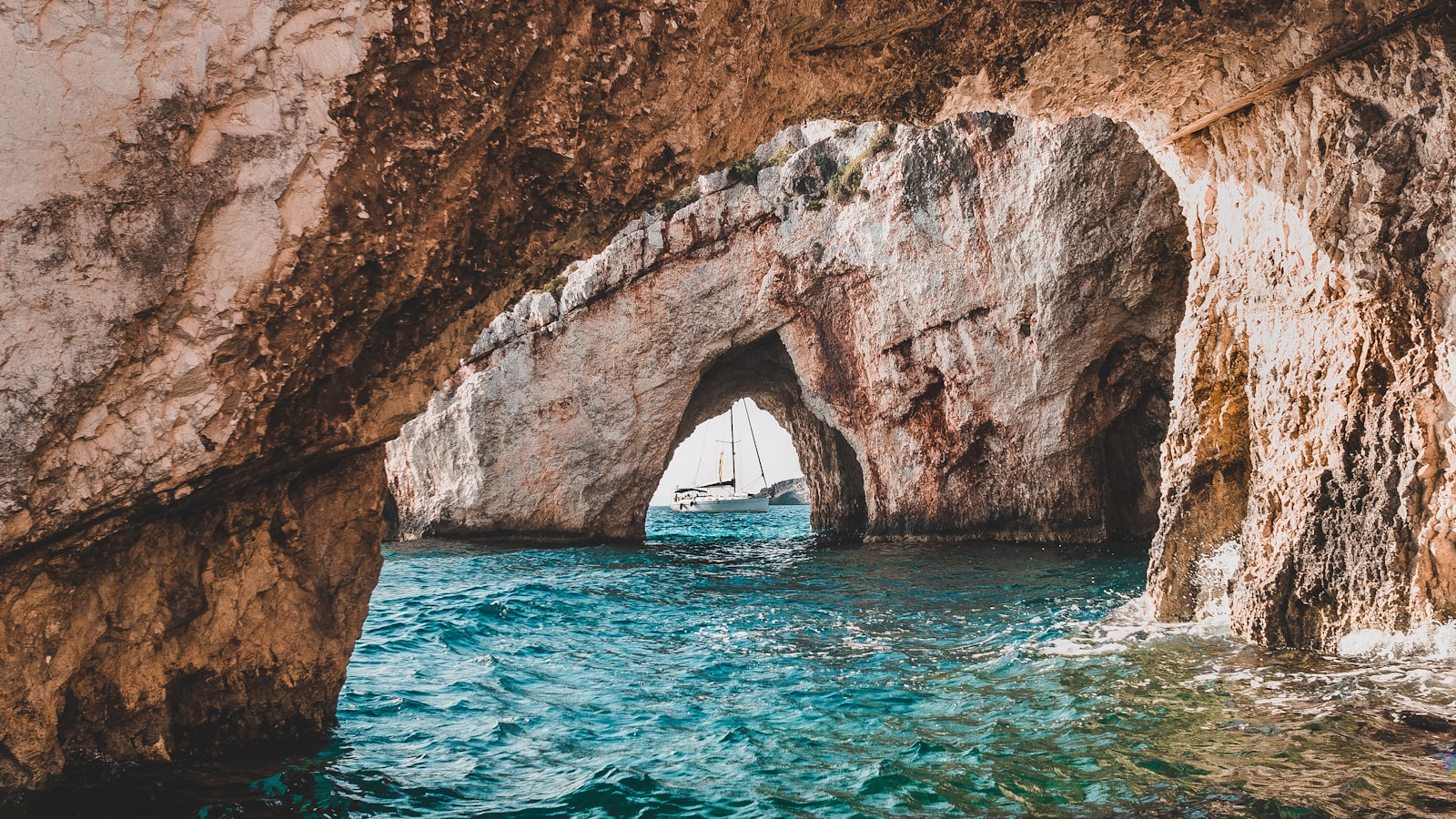 Boats resting inside a rocky sea cove in the south of Italy